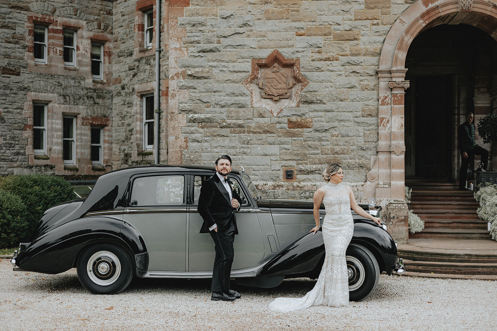A couple beside a vintage car at Castle Leslie in Ireland